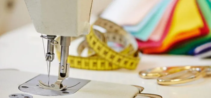 Close-up of a sewing machine with spools of thread