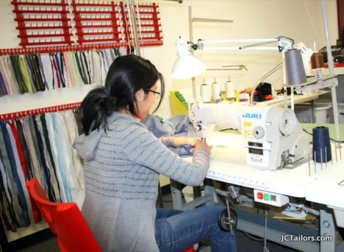 Pants being pinned and measured for hemming